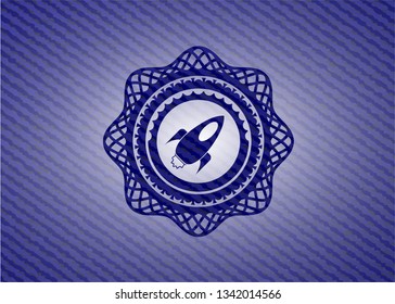 rocket icon inside emblem with jean background