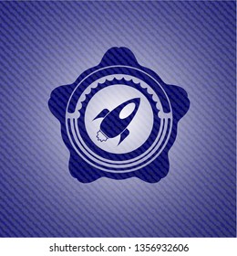 rocket icon inside emblem with jean texture