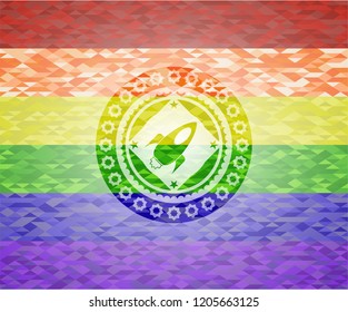 rocket icon inside emblem on mosaic background with the colors of the LGBT flag