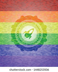 rocket icon inside emblem on mosaic background with the colors of the LGBT flag