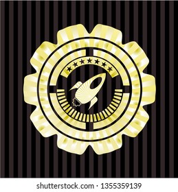 rocket icon inside gold emblem