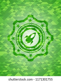rocket icon inside green emblem with mosaic background