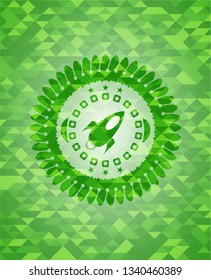 rocket icon inside green emblem with mosaic background