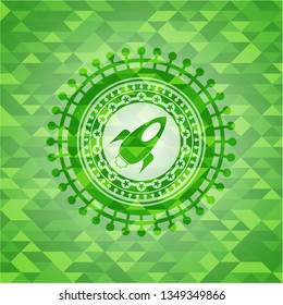 rocket icon inside green emblem with mosaic background
