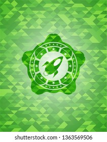 rocket icon inside green emblem with mosaic background