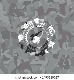 rocket icon inside grey camo emblem