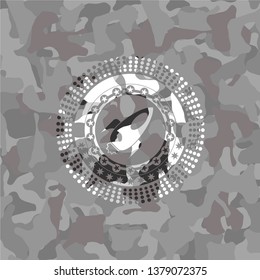 rocket icon inside grey camouflage emblem
