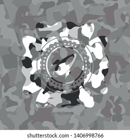 rocket icon inside grey camouflage emblem