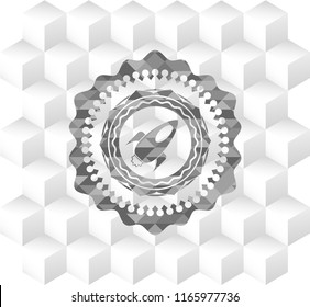 rocket icon inside grey emblem with cube white background