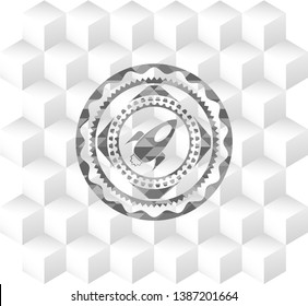 rocket icon inside grey icon or emblem with geometric cube white background