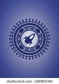 rocket icon inside jean or denim emblem or badge background