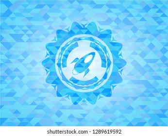 rocket icon inside light blue emblem with mosaic background