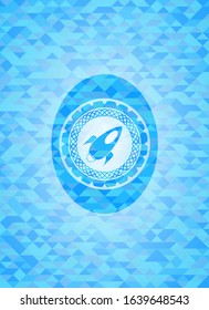 rocket icon inside light blue emblem with mosaic background