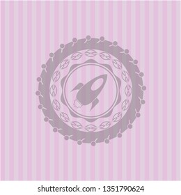 rocket icon inside pink emblem