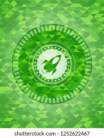 rocket icon inside realistic green mosaic emblem