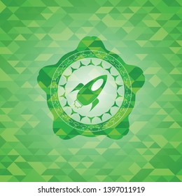rocket icon inside realistic green emblem. Mosaic background