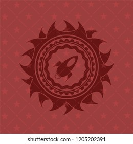 rocket icon inside realistic red emblem