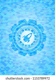 rocket icon inside realistic sky blue mosaic emblem