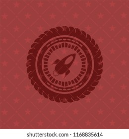 rocket icon inside red emblem