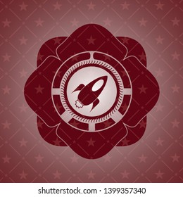 rocket icon inside red emblem