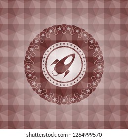 rocket icon inside red seamless geometric emblem.