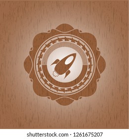 rocket icon inside retro style wooden emblem