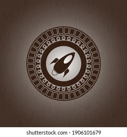 rocket icon inside retro style wood emblem. 