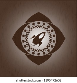 rocket icon inside retro wooden emblem