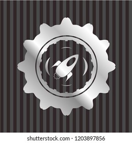 rocket icon inside silver badge or emblem