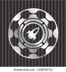 rocket icon inside silver emblem or badge