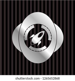 rocket icon inside silver emblem