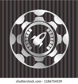 rocket icon inside silvery badge or emblem