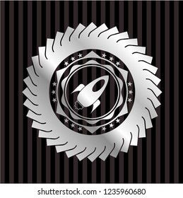 rocket icon inside silvery badge