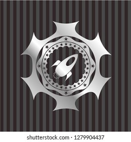 rocket icon inside silvery badge or emblem