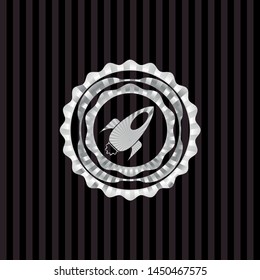 rocket icon inside silvery badge