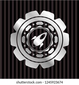 rocket icon inside silvery emblem or badge