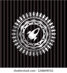 rocket icon inside silvery emblem