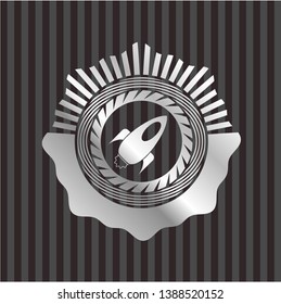 rocket icon inside silvery emblem