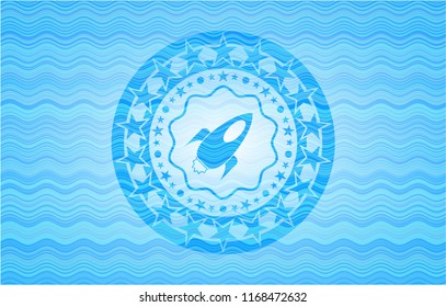 rocket icon inside sky blue water emblem background.