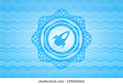rocket icon inside sky blue water wave emblem.