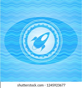 rocket icon inside water emblem background.