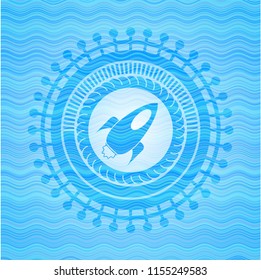 rocket icon inside water wave representation style badge.