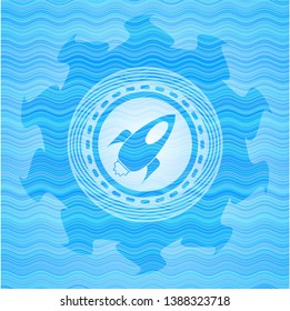 rocket icon inside water wave representation badge.