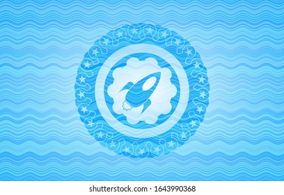 rocket icon inside water wave representation style badge.