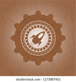 rocket icon inside wood badge or emblem