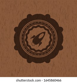 rocket icon inside wood badge or emblem