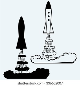 Rocket icon. Isolated on blue background. Vector silhouettes