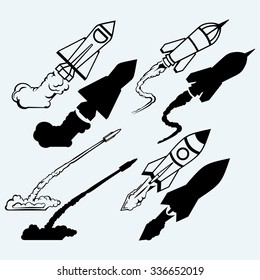Rocket icon. Isolated on blue background. Vector silhouettes