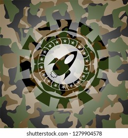 rocket icon on camouflaged pattern