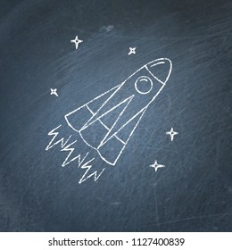 Rocket icon on chalkboard